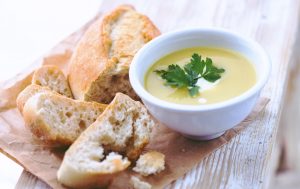 A bowl of soup with bread